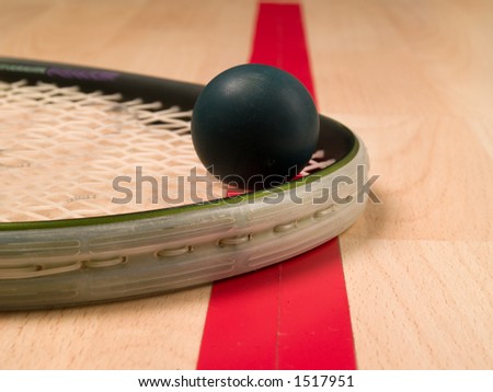 Squash ball and racket next to a red line