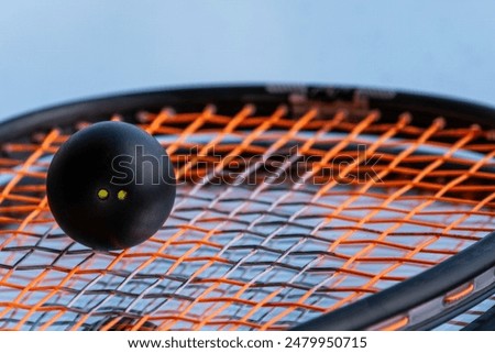 Squash balls on the background of a squash racket with a mirror image. Squash equipment for game.