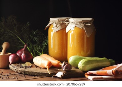 Squash caviar from zucchini, carrot, onions, spices on darkk moody rustic wooden background, closeup, homemade food in plastic free jars, sustainable living and saving leftovers concept