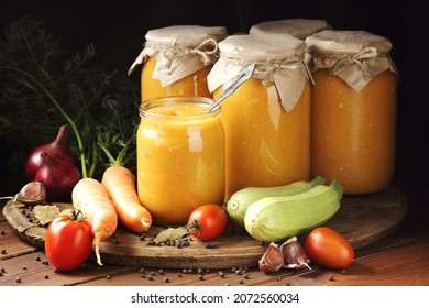 Squash caviar from zucchini, carrot, onions, spices on darkk moody rustic wooden background, closeup, homemade food in plastic free jars, sustainable living and saving leftovers concept