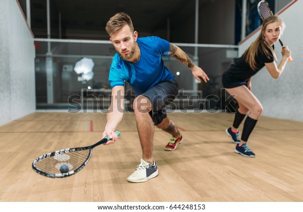 Squash game training,\
players with rackets