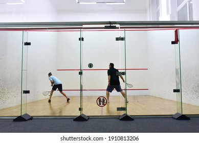 Squash player in action reaching on squash court. Squash Players on Tournament. Sports equipment and sportswear for playing squash.  Soft focus