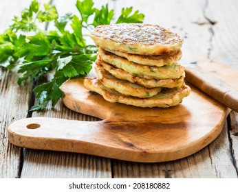 Squash and  zucchini fritters on wooden table