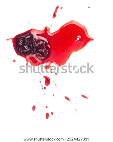 Squashed ripe sour cherry in the puddle of red juice isolated on white
