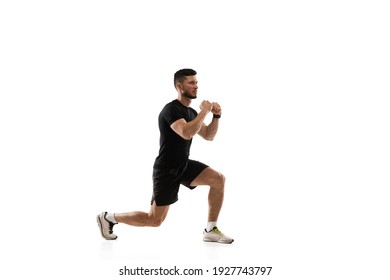 Squats. Caucasian professional sportsman training isolated on white studio background. Muscular, sportive man practicing. Copyspace. Concept of action, motion, youth, healthy lifestyle.