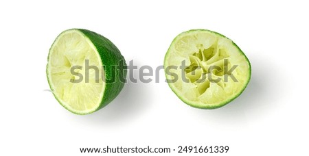 Squeezed lime, squeezing out half green lemon, squeezed lime juice on white background, burnout symbol, making a Cuba Libre cocktail
