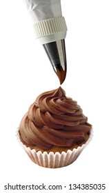 Squeezing Chocolate Cream With Piping Or Icing Bag On Cupcake Isolated On White Background.