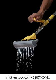 Squeezing Mop With Dirty Water Isolated On Black Background