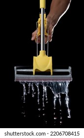 Squeezing Mop With Dirty Water Isolated On Black Background