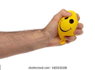 Squeezing Stress Ball In The Male Hand Isolated On White