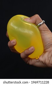 
Squeezing A Yellow Water Balloon