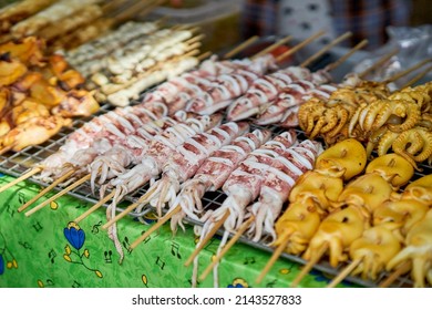 Squid Being Cooked On A Grill At A Local Seafood Market.    