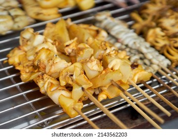 Squid Being Cooked On A Grill At A Local Seafood Market.    