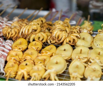 Squid Being Cooked On A Grill At A Local Seafood Market.    