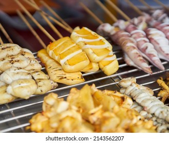 Squid Being Cooked On A Grill At A Local Seafood Market.    