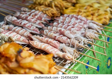 Squid Being Cooked On A Grill At A Local Seafood Market.    