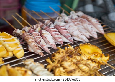 Squid Being Cooked On A Grill At A Local Seafood Market.    