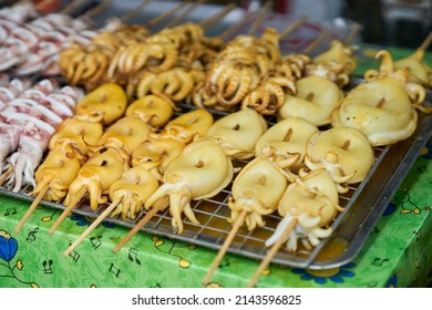 Squid Being Cooked On A Grill At A Local Seafood Market.    