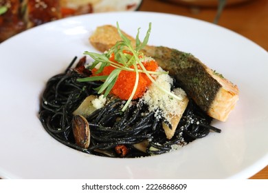 Squid Ink Pasta with Grilled Tuna Steak and White Wine Sauce Topping with Sunflower Sprout Leaves and Ebiko Prawn.  - Powered by Shutterstock