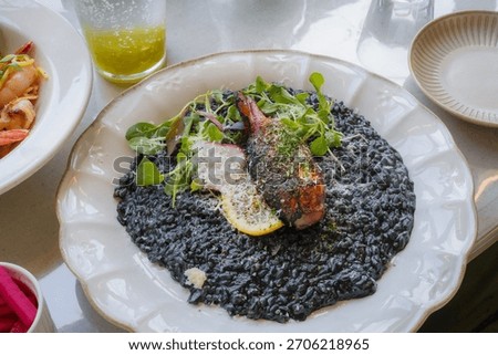 Squid Ink Risotto Topped with Grilled Calamari