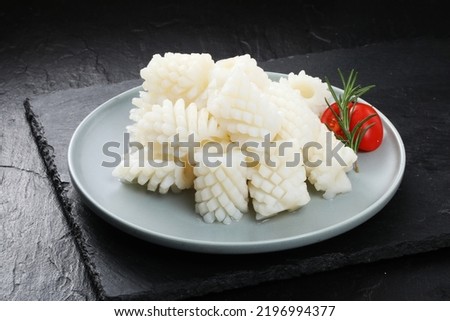 Squid, pineapple cut isolated on black background