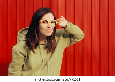 
Squinting Woman Wearing Eyeglasses Trying To See In The Distance. Myopic Person Looking In The Distance With Her New Glasses 
