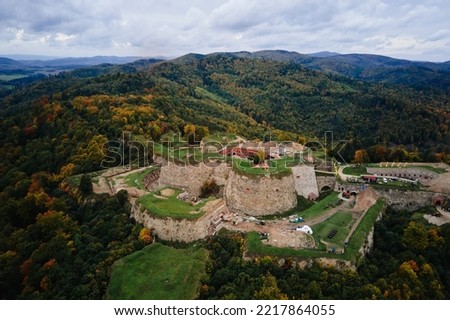 Srebrna Gora fortress and Sudety mountains at autumn season, aerial drone view. Military fort landmark for tourists in Lower Silesia, Poland