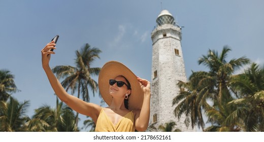 Sri Lanka Tourist Girl On Holiday Taking Selfie Photo With Phone At Famous Place Dondra Lighthouse, Asian Tourism Attraction.