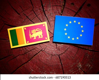 Sri Lankan flag with EU flag on a tree stump isolated