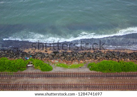 Srilankan beachside along with railroadtrack, stones are placed to protect the railway track