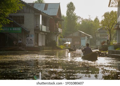  SRINAGAR, INDIA -21 JULY 2018: Floating convenience shop selling packed food items in the middle of Srinagar Lake's village, at sunset. Kashmir, India