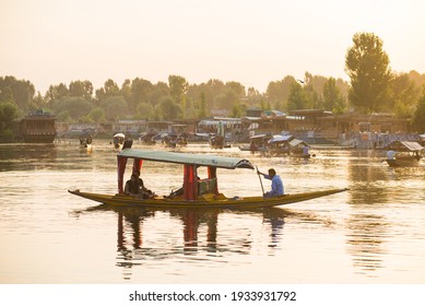  Srinagar, India - 21 JULY 2018. Sunset of wooden boats on Dal Lake in Srinagar, India. The lake, situated in the northeast of Srinagar, is one of the most beautiful lakes in India.