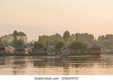  Srinagar, India - 21 JULY 2018. Sunset of wooden boats on Dal Lake in Srinagar, India. The lake, situated in the northeast of Srinagar, is one of the most beautiful lakes in India.