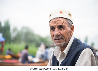 SRINAGAR, INDIA 21 - JULY, 2018 : Lifestyle in Dal lake, An elderly Kashmiri muslim man with grey beard and skull cap on his boat in the famous dal lake of srinagar.