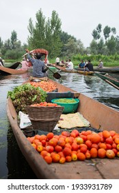  SRINAGAR , INDIA ;22 JULY 2018 : vegetable vendors sell their produce on their boat at  morning floating vegetable market - Dal Lake