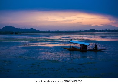 SRINAGAR, INDIA - APRIL 13: Sunset at Dal Lake, It is the second largest in the state, Local people and traveler are use small wooden boat call 'Shikara' is a vehicle in the lake on Apr 13, 2014