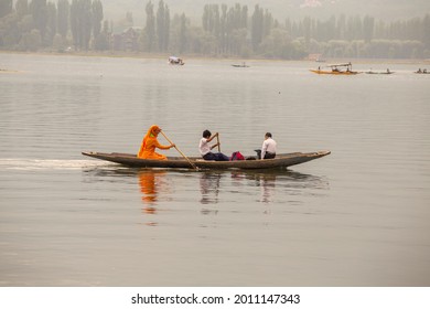 Srinagar, India - july 02, 2015 : Lifestyle in Dal lake, local people use Shikara, a small boat for transportation in lake of Srinagar, Jammu and Kashmir, India. Indian mom and her two sons on a boat