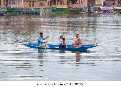 Srinagar, India - july 02, 2015 : Lifestyle in Dal lake, local people use Shikara, a small boat for transportation in the lake of Srinagar, Jammu and Kashmir state, India. Indian family on a boat