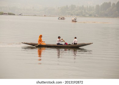 Srinagar, India - july 02, 2015 : Lifestyle in Dal lake, local people use Shikara, a small boat for transportation in lake of Srinagar, Jammu and Kashmir, India. Indian mom and her two sons on a boat