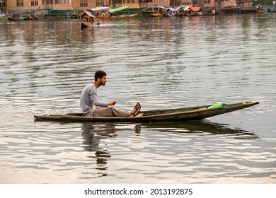 Srinagar, India - july 02, 2015 : Lifestyle in Dal lake, local people use Shikara, a small boat for transportation in the lake of Srinagar, Jammu and Kashmir state, India. Indian man on a boat