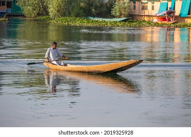Srinagar, India - july 02, 2015 : Lifestyle in Dal lake, local people use Shikara, a small boat for transportation in the lake of Srinagar, Jammu and Kashmir state, India. Indian man on a boat