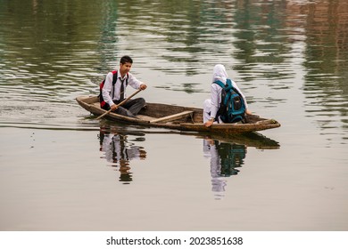 Srinagar, India - july 02, 2015 : Lifestyle in Dal lake, local people use Shikara, a small boat for transportation in lake of Srinagar, Jammu and Kashmir state, India. Indian guy and girl on a boat