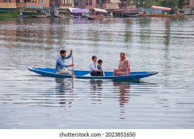 Srinagar, India - july 02, 2015 : Lifestyle in Dal lake, local people use Shikara, a small boat for transportation in the lake of Srinagar, Jammu and Kashmir state, India. Indian family on a boat