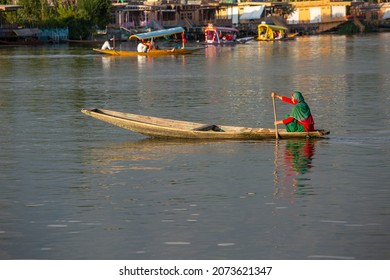 Srinagar, India - july 02, 2015 : Lifestyle in Dal lake, local people use Shikara, a small boat for transportation in the lake of Srinagar, Jammu and Kashmir state, India. Indian woman on a boat