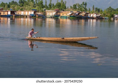 Srinagar, India - july 03, 2015 : Lifestyle in Dal lake, local people use Shikara, a small boat for transportation in the lake of Srinagar, Jammu and Kashmir state, India. Indian man on a boat