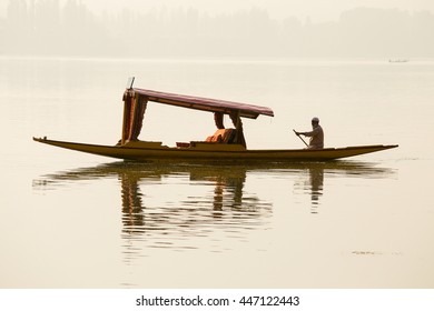 SRINAGAR, INDIA - JULY 07, 2015 : Lifestyle in Dal lake, local people use Shikara, a small boat for transportation in the lake of Srinagar, Jammu and Kashmir state, India