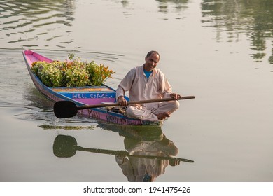 Srinagar, India - june 07, 2015 : Lifestyle in Dal lake, local people use Shikara, a small boat for transportation in the lake of Srinagar, Jammu and Kashmir state, India. Indian man sells flowers
