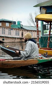 SRINAGAR, INDIA - Mar 01, 2022: A portrait of a Kashmiri Shikara boat sailor Indian man on Dal Lake  The hands might be blurred due to motion 
