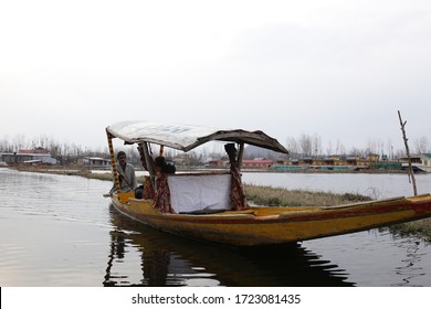 SRINAGAR, INDIA - March 19,2019: in Dal lake, local people use 'Shikara', a small boat for transportation in the lake of Srinagar, Jammu and Kashmir state, India.
