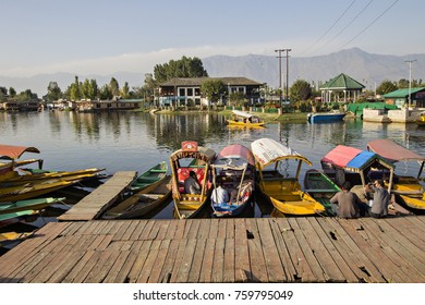 SRINAGAR, INDIA - October 2017: Dal lake at sunset time. Shikara boats on the water at Dal lake in the evening, Srinagar, Jammu and Kashmir, India